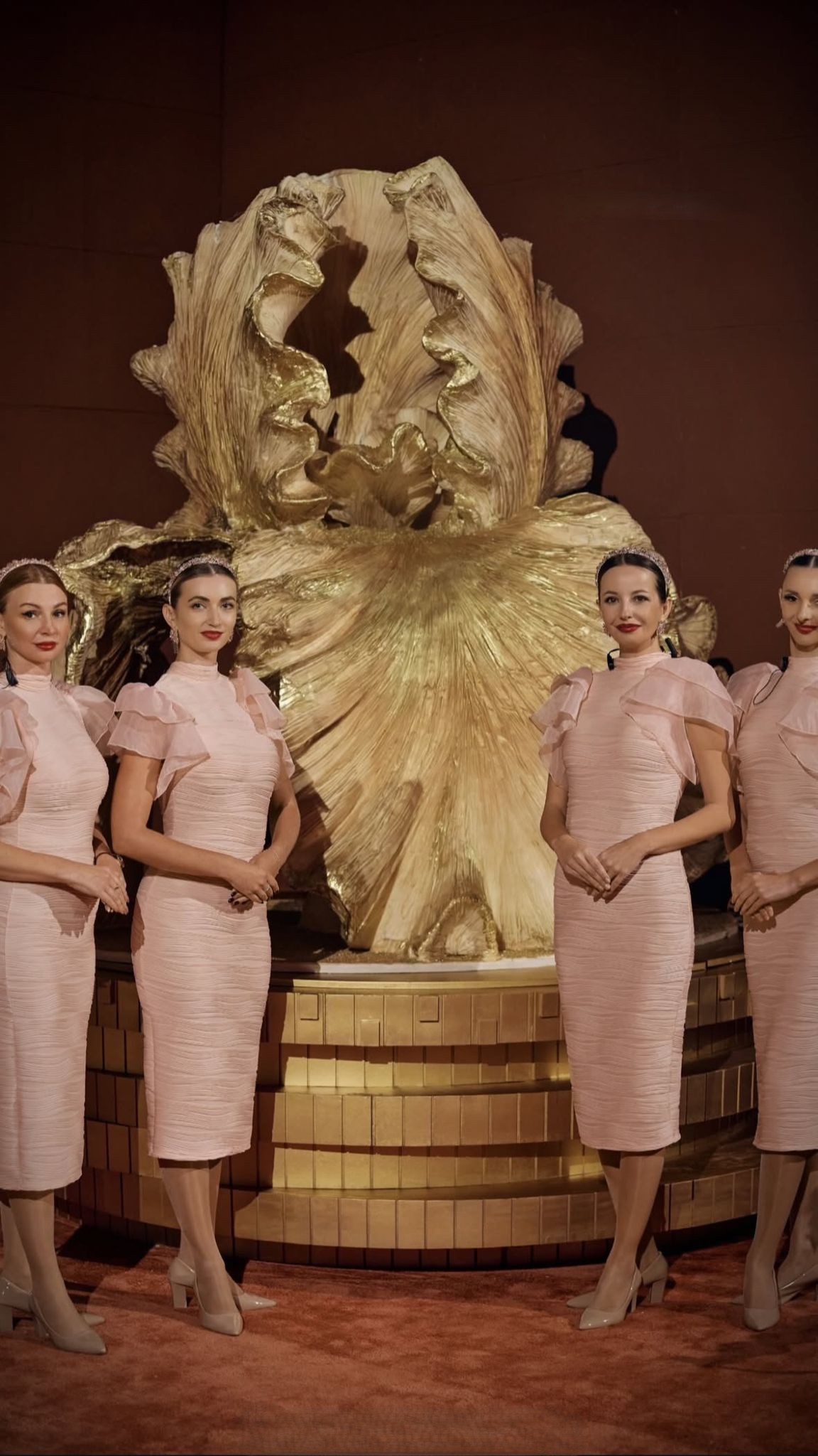 Monumental 2.5-meter sculpted golden floral wedding cake designed in Qatar and revealed as the statement centrepiece of a luxury wedding in Dubai.